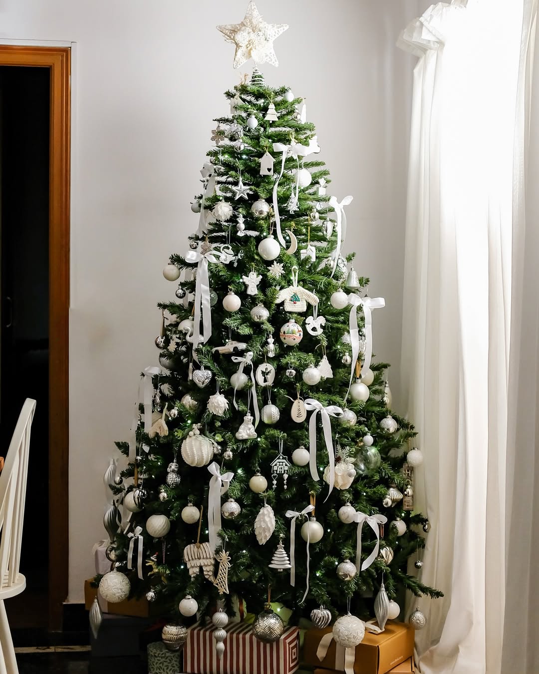 6 feet Evergreen Spruce artificial Christmas tree decorated with white Christmas ornaments